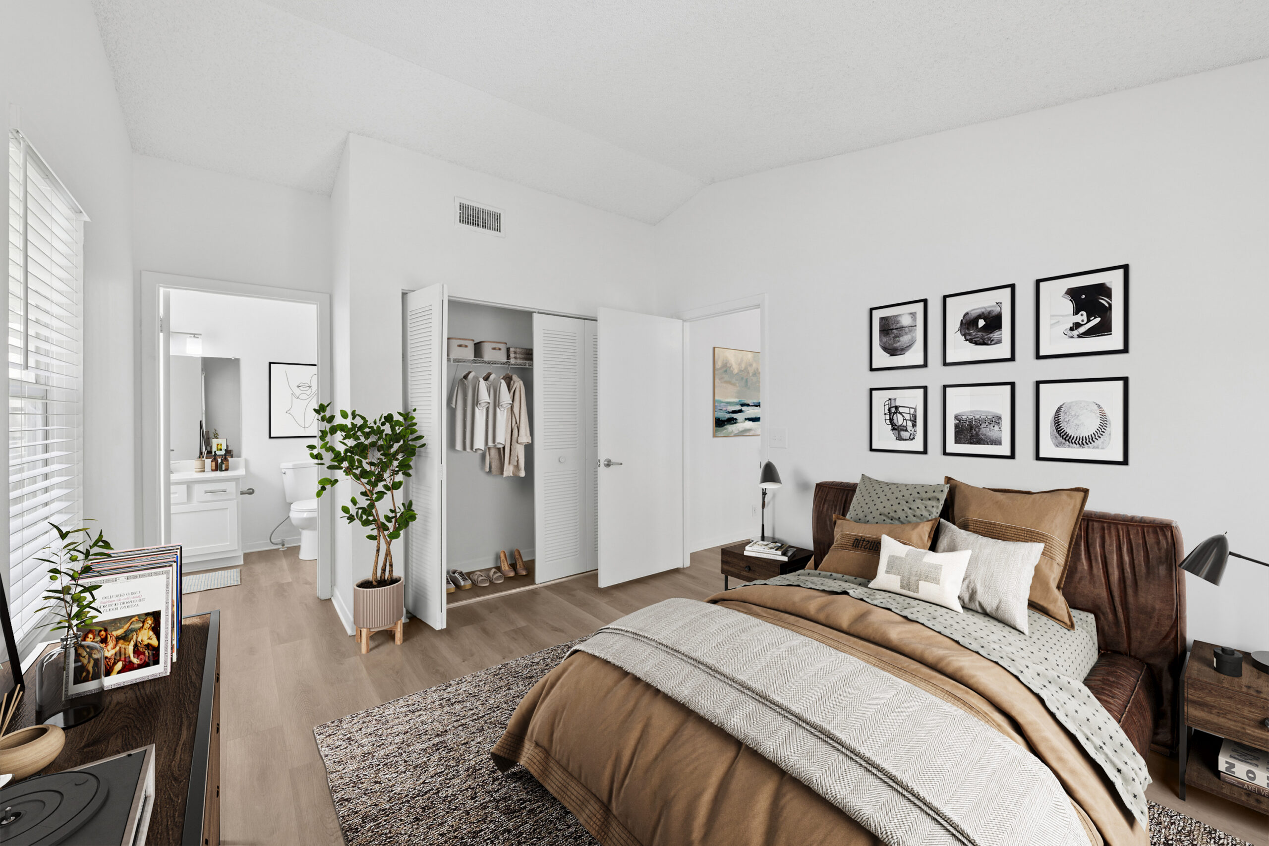 Spacious bedroom with ample natural lighting and plank flooring