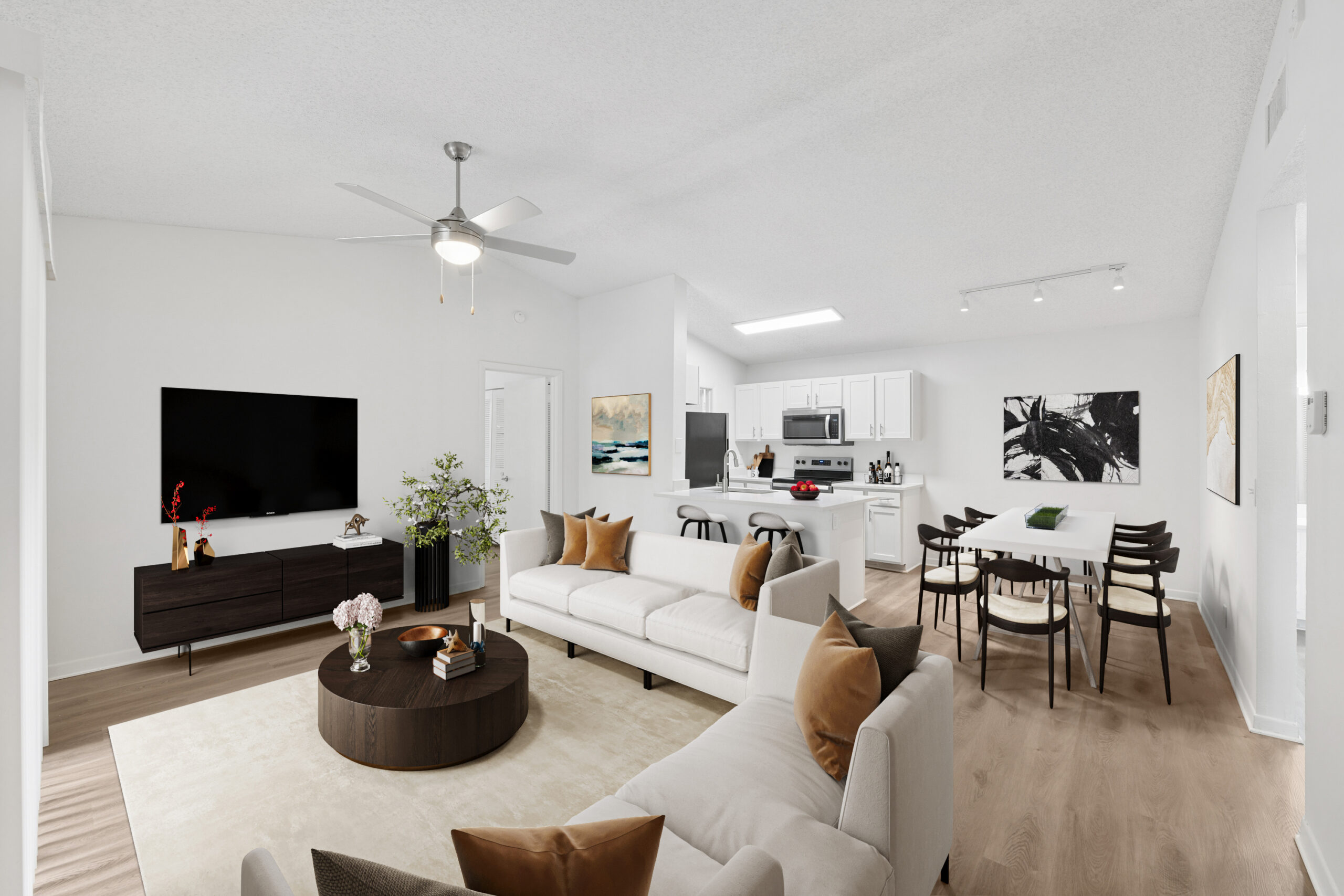 Open concept living room with dining space, plank flooring, and ceiling fan