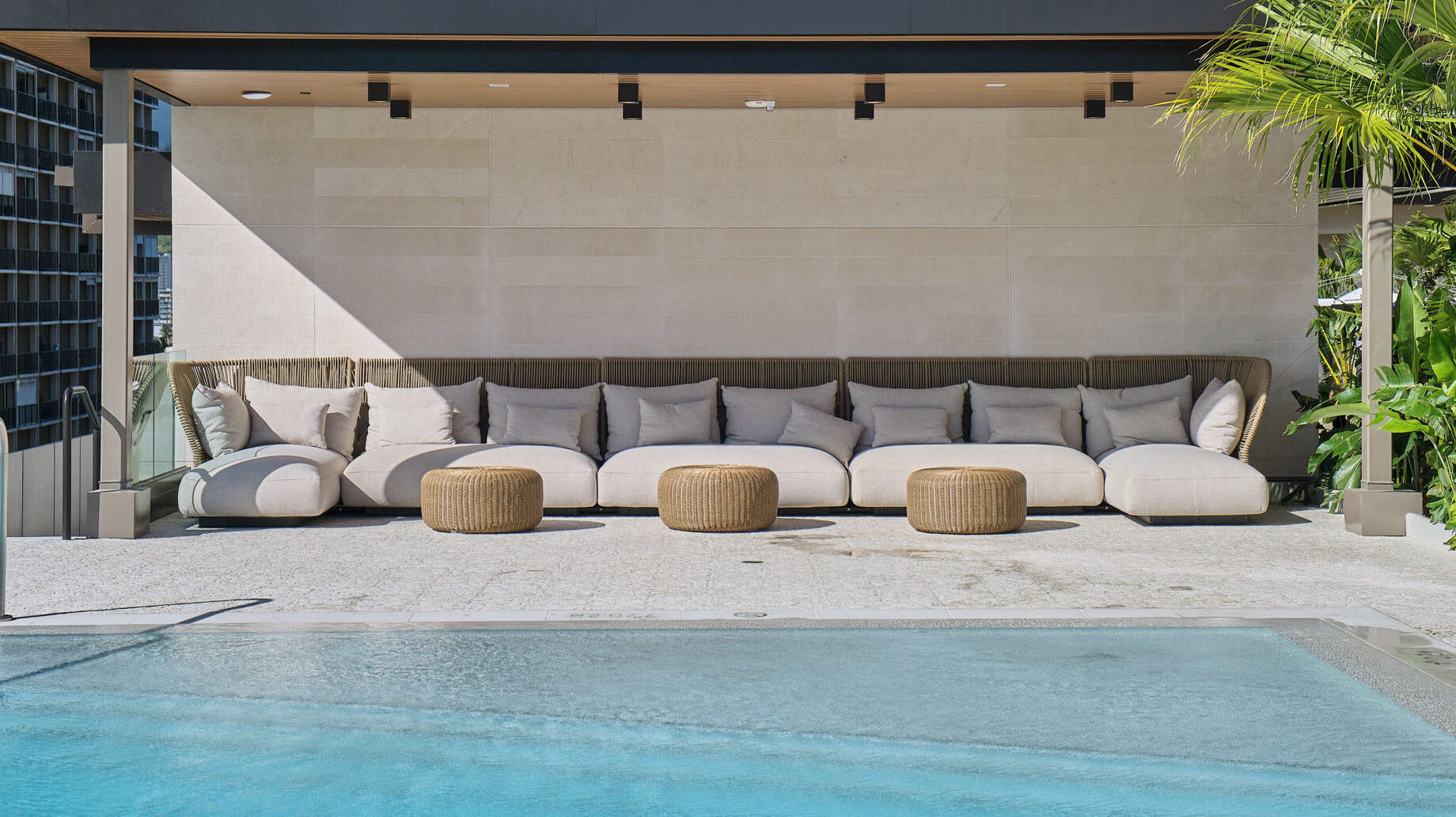 Resort-style pool with cabana area with plush seating.