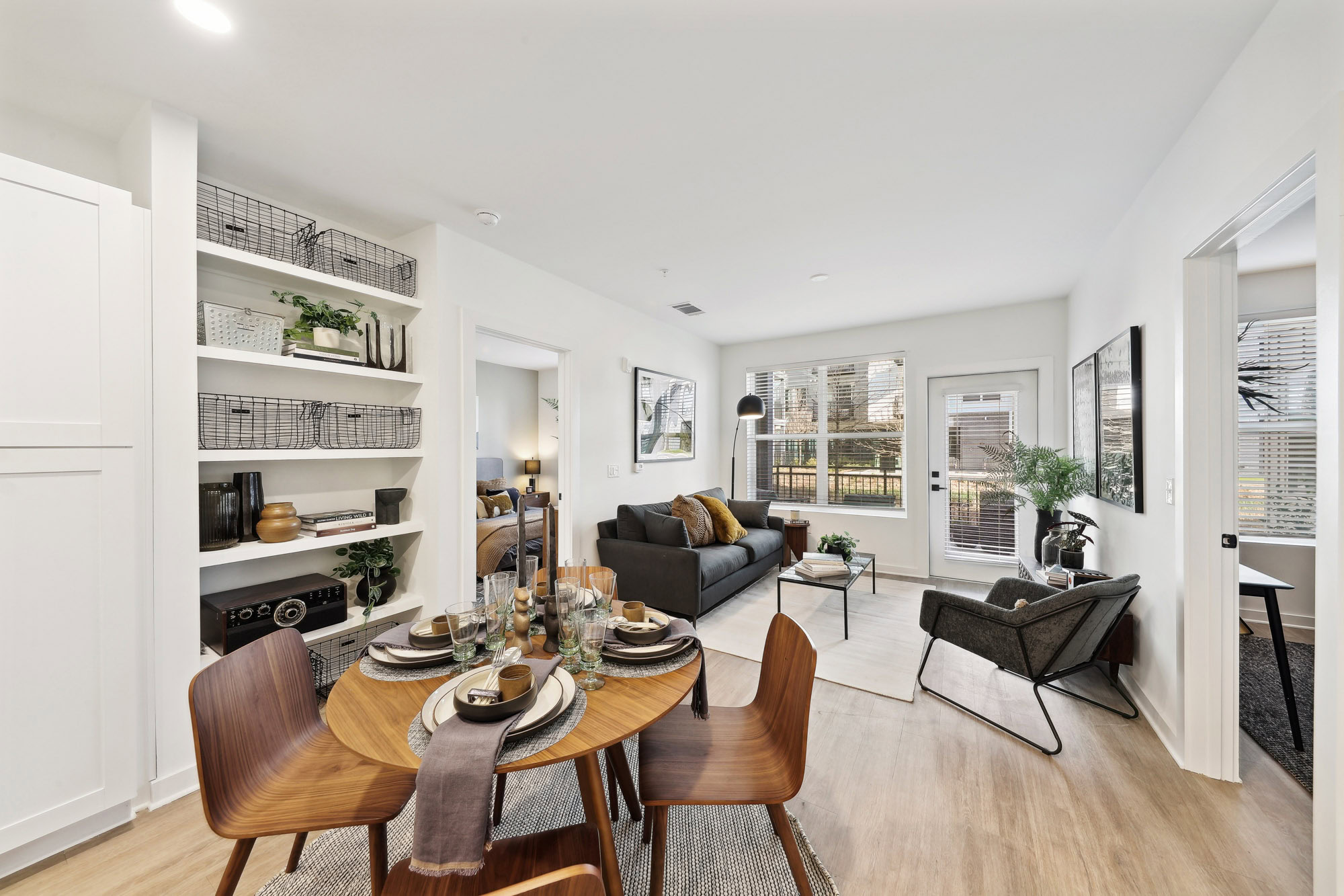A dining area and living room in an open plan kitchen in a Tallulah apartment in Cumberland, GA