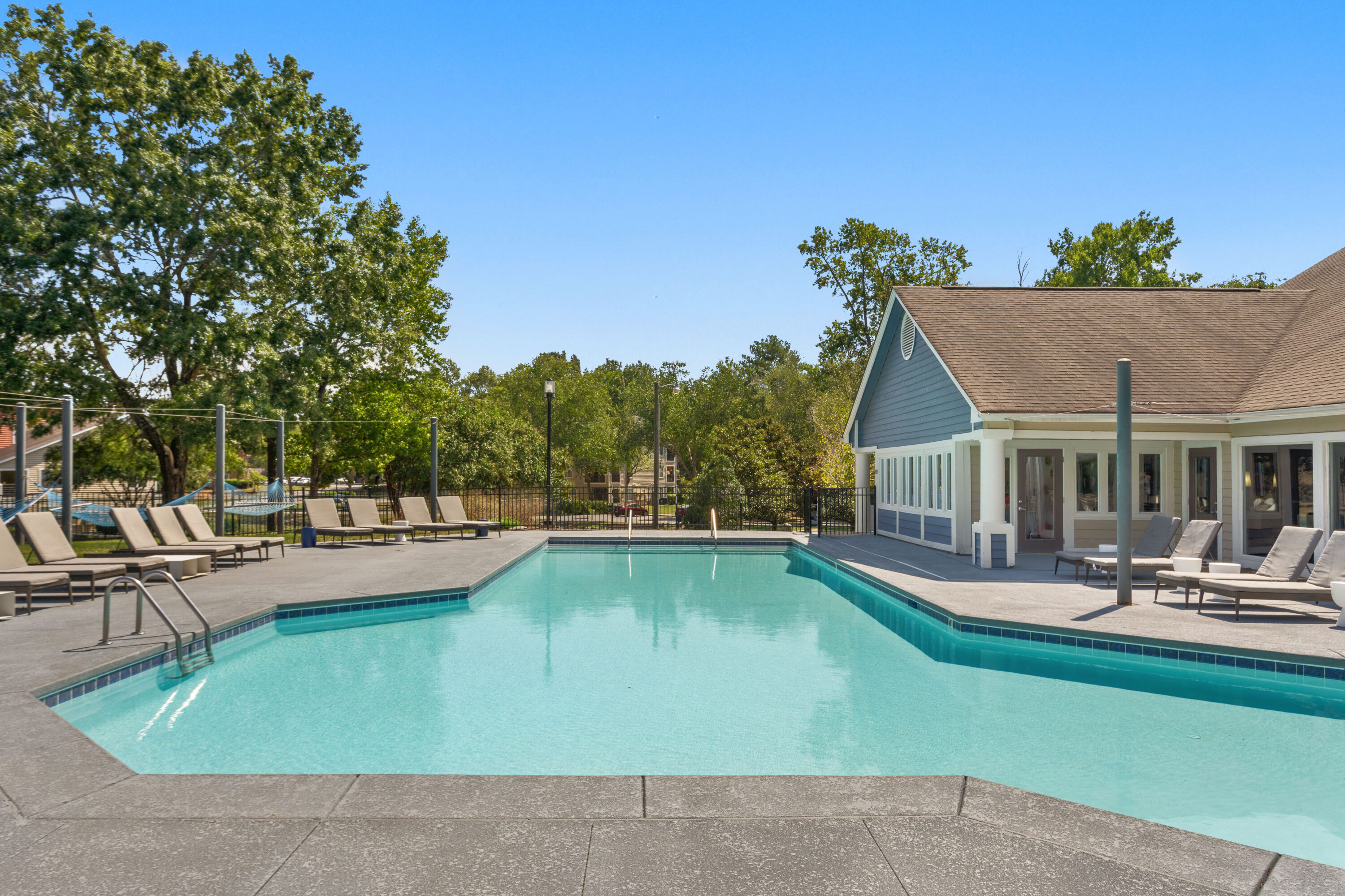 Outdoor pool with sundeck and hammock garden