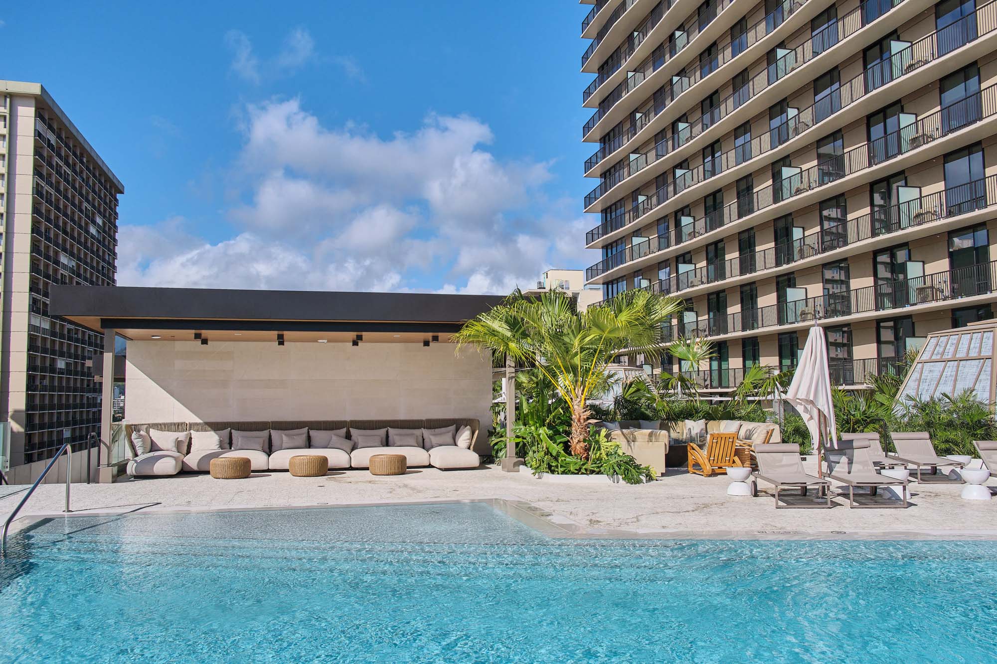 Fluffy lounge chairs situated around the pool offer a space to relax out of the sun.