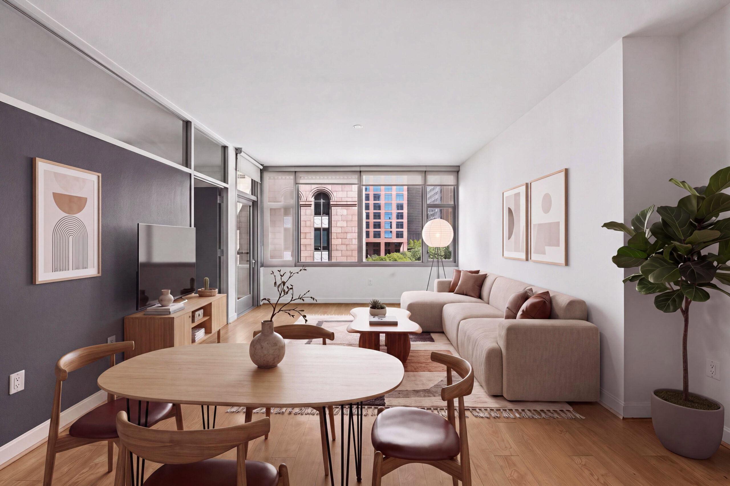 Modern open-concept apartment with a spacious living room, dining area, wood-style flooring and kitchen with stainless steel appliances.