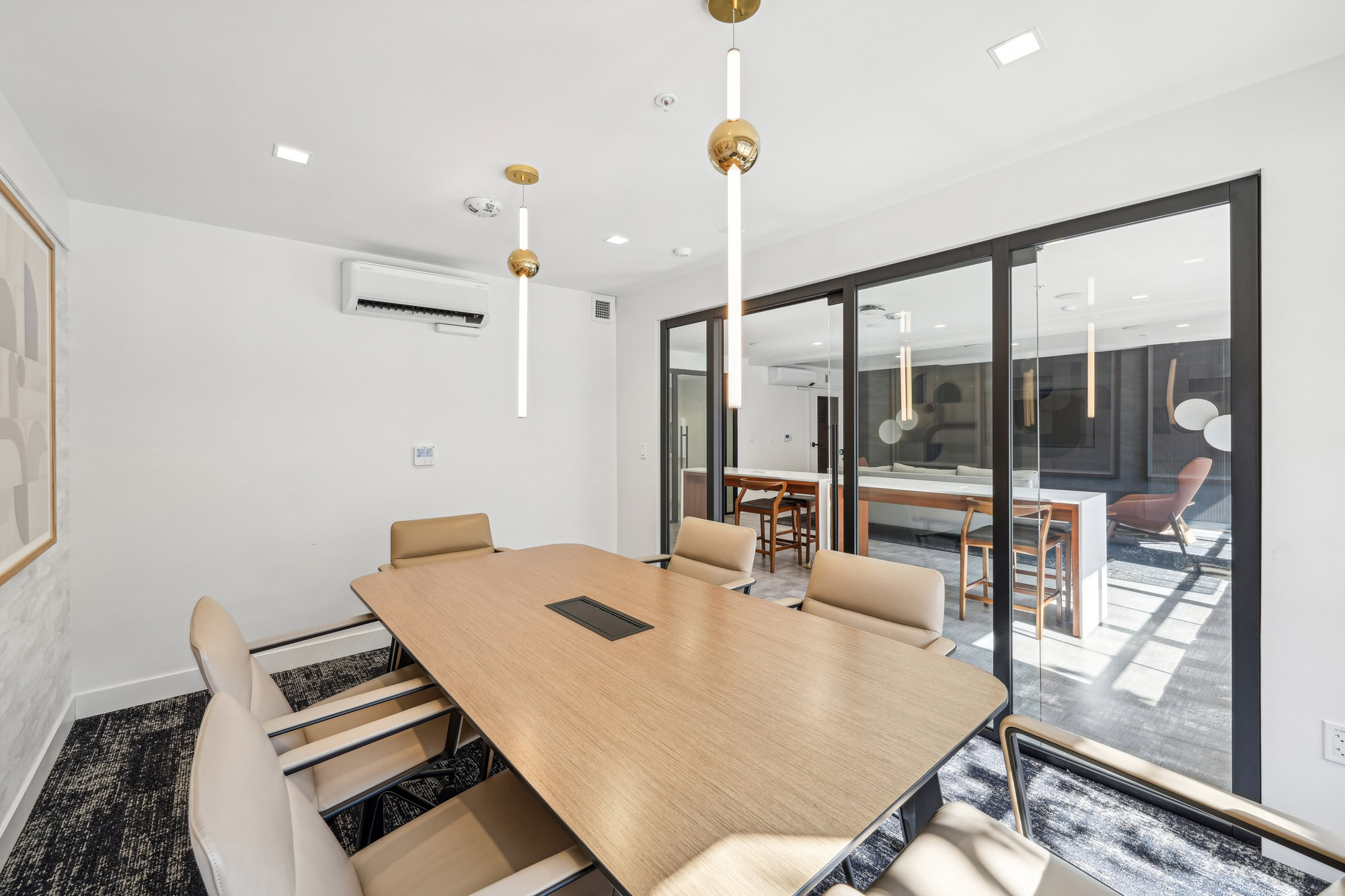 A private conference table with a glass wall and door at Bayside Village modern apartments in San Francisco