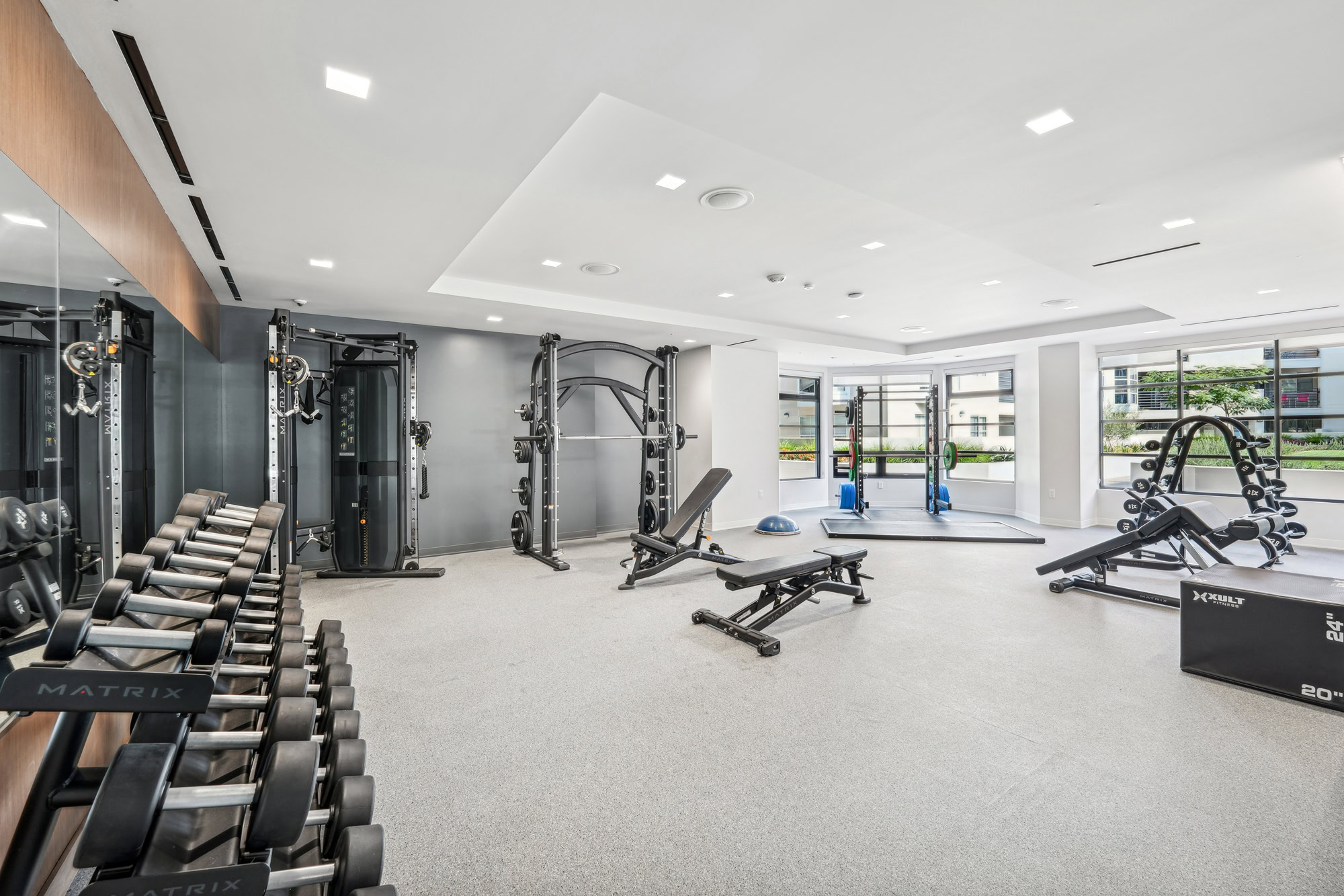A fully equipped fitness center with machines and weights at Bayside Village in downtown San Francisco