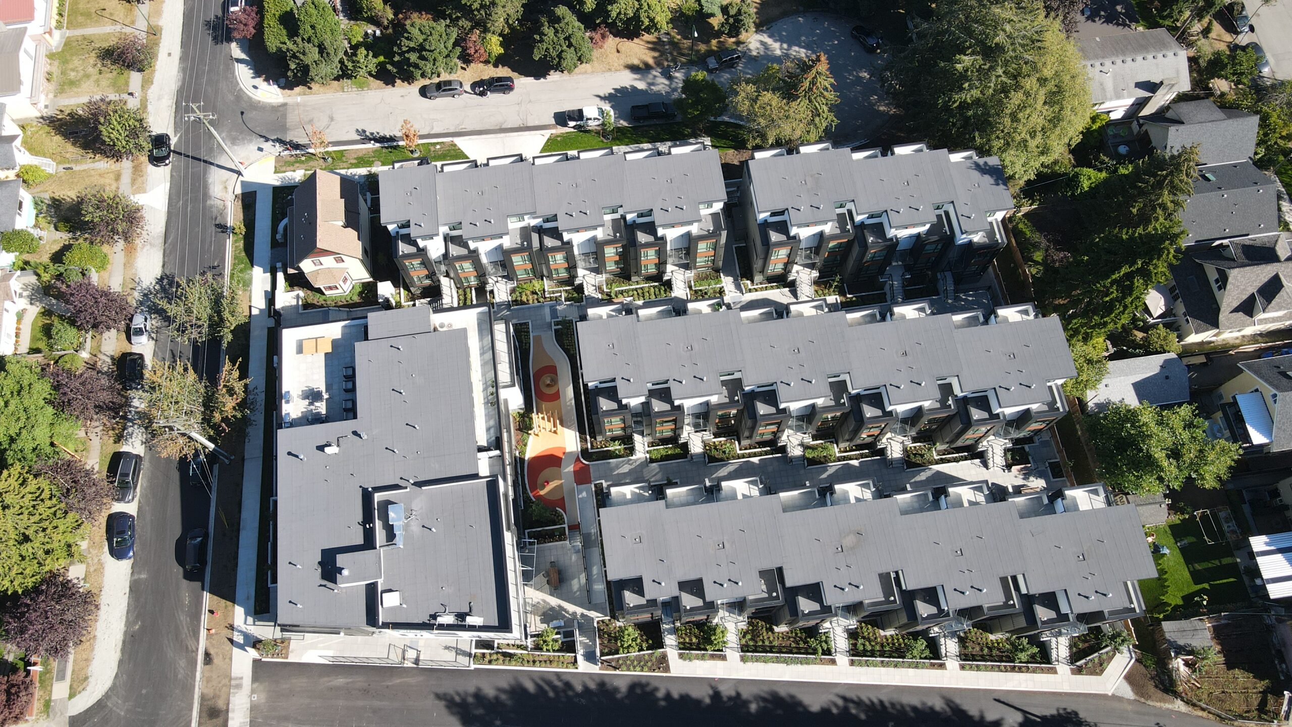 An aerial image of the apartment rooftops of the Hendry Place trout lake apartments