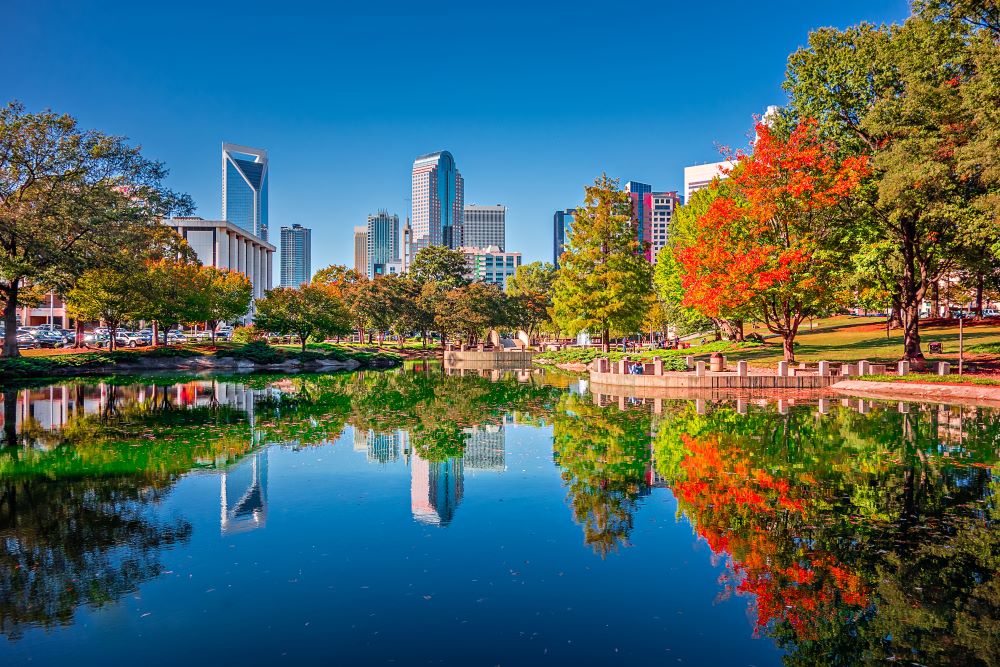 A view of downtown charlotte reflected in a water feature near apartments for rent in Charlotte NC