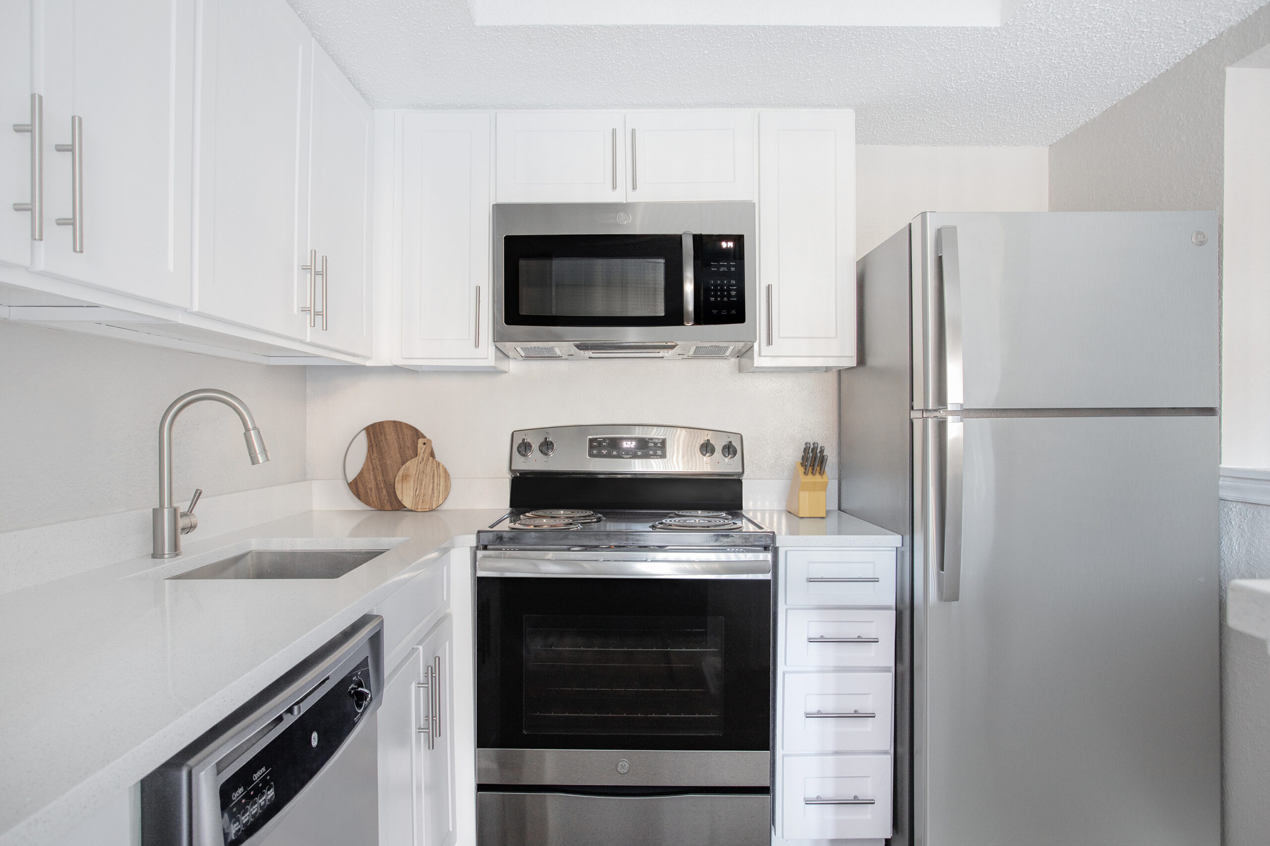 Beacon Hill modern updated kitchen with stainless steel appliances and granite like countertops