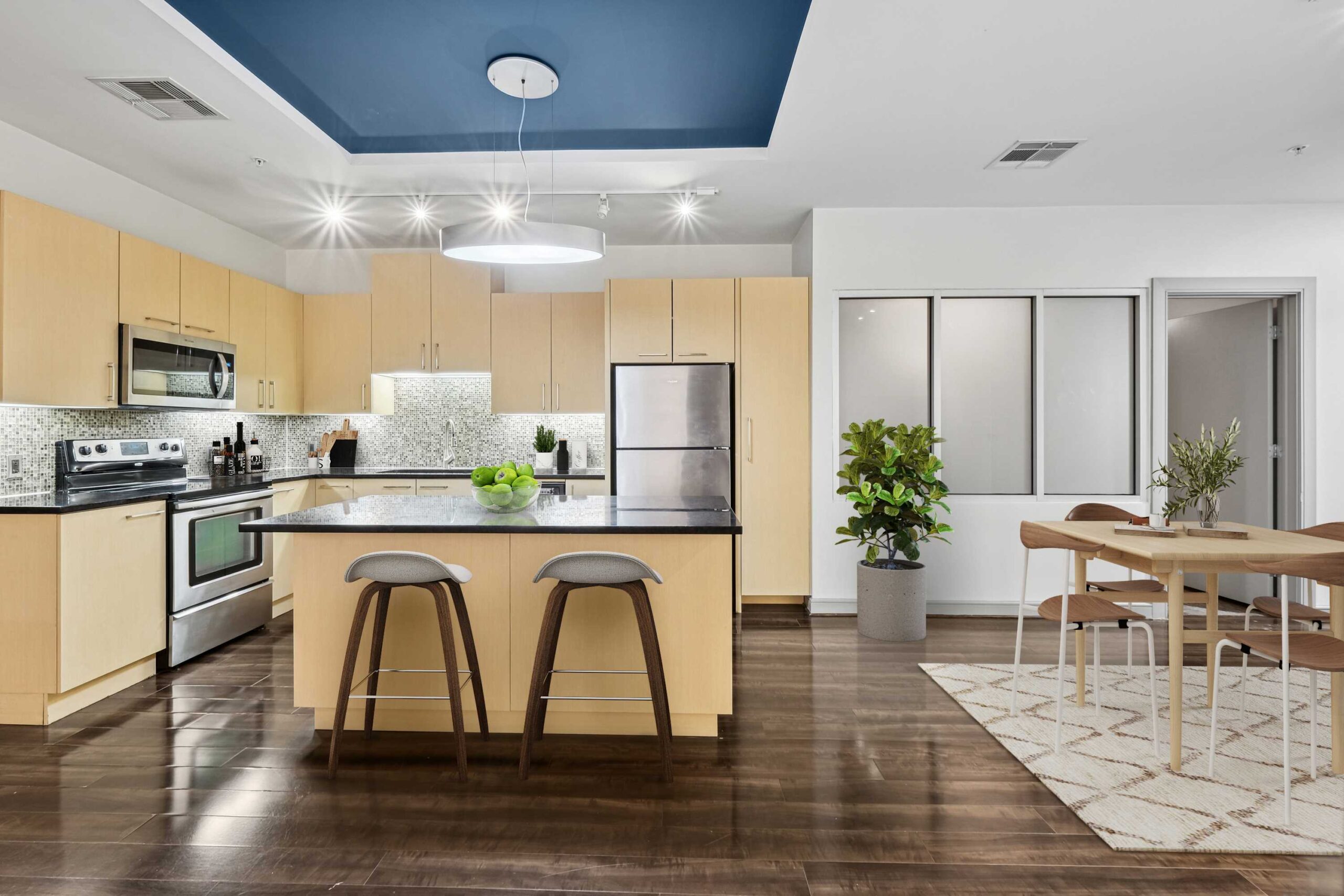 Modern club room kitchen and dining space at The Continental's apartments in Dallas, Texas