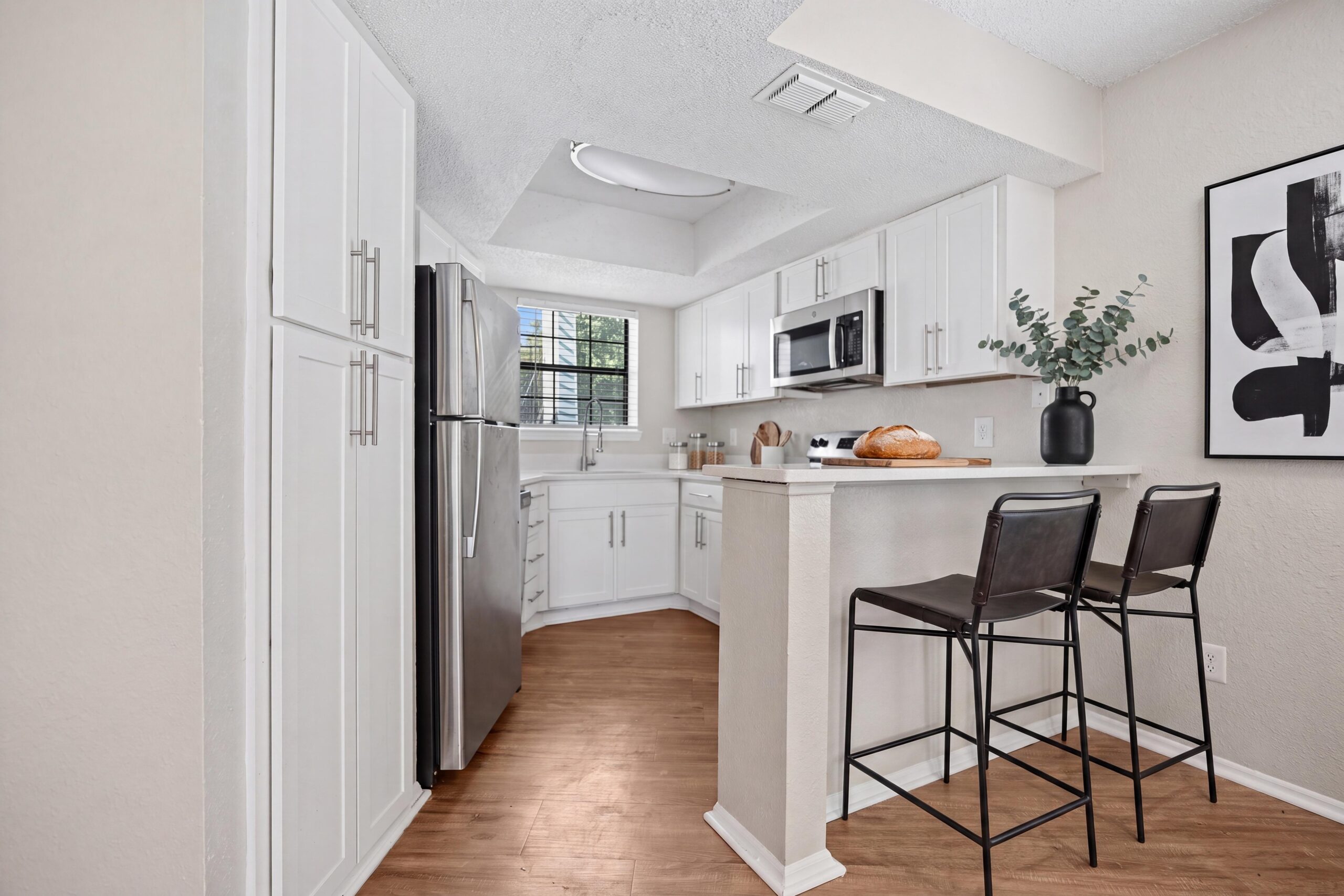 Kitchen with stainless steel appliances, granite countertops, and custom cabinetry.