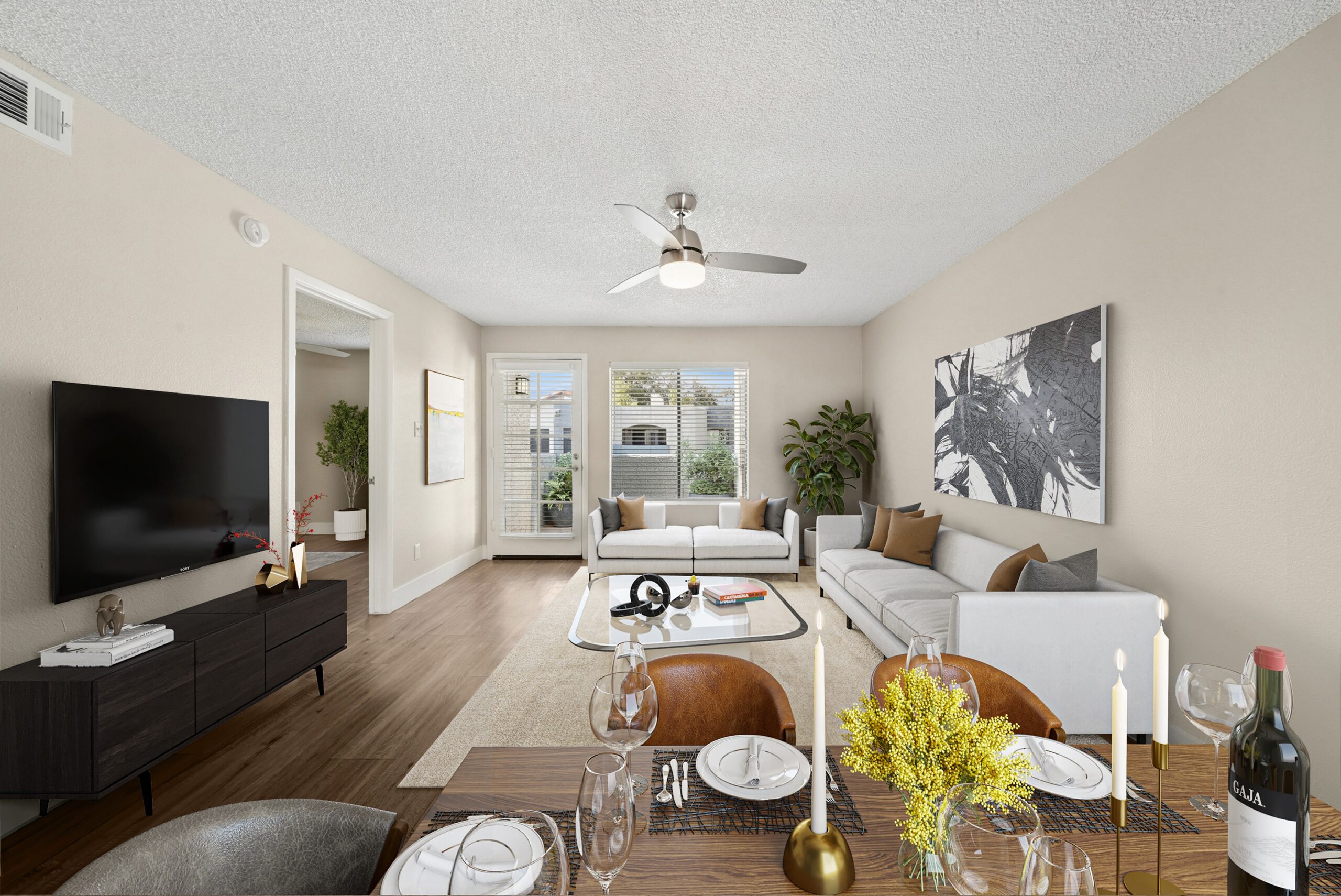 Open living and dining area at Arches at Hidden Creek featuring modern furnishings, wood-style flooring and abundant natural light.