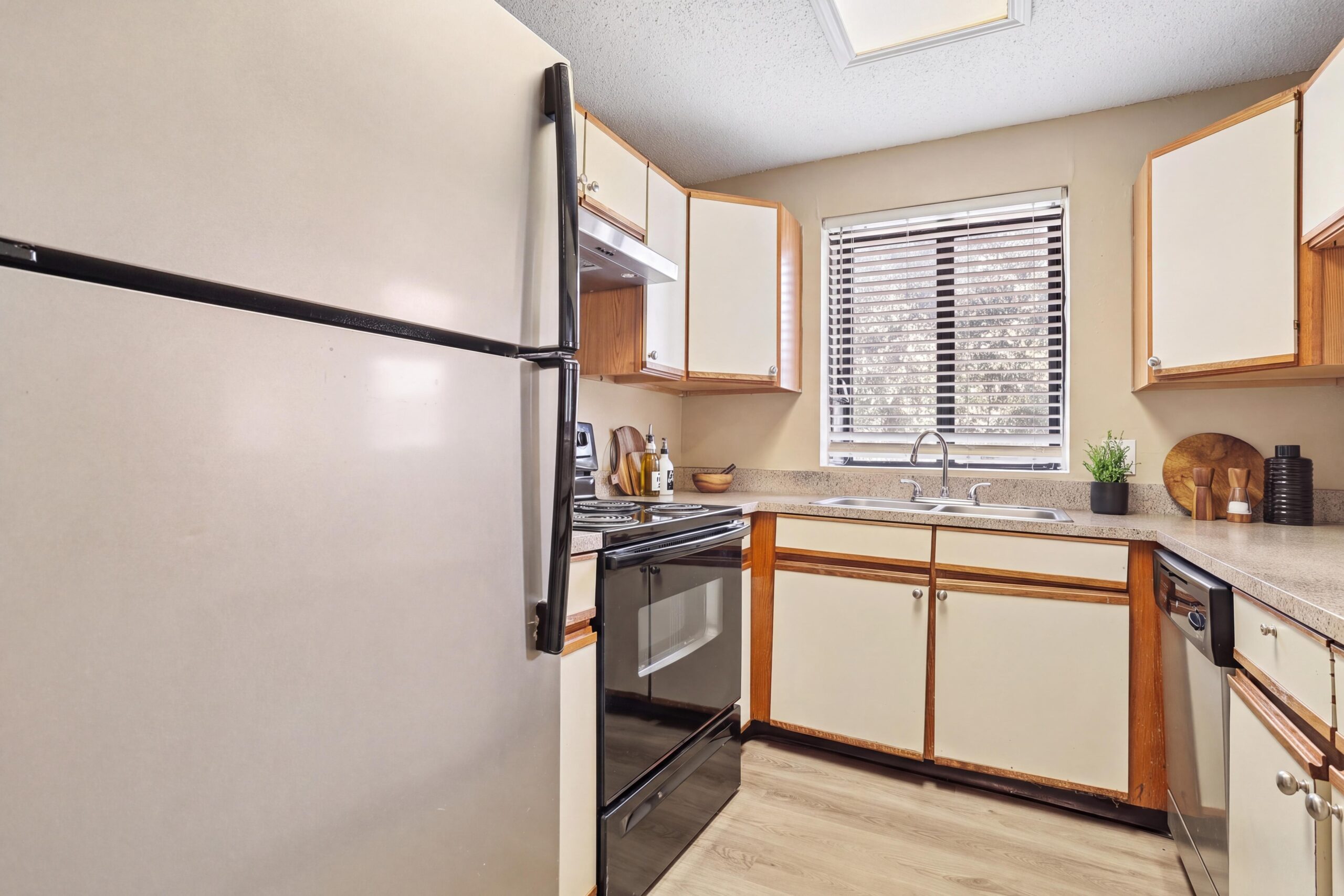 Lake Village West kitchen with white cabinetry and stainless appliances.