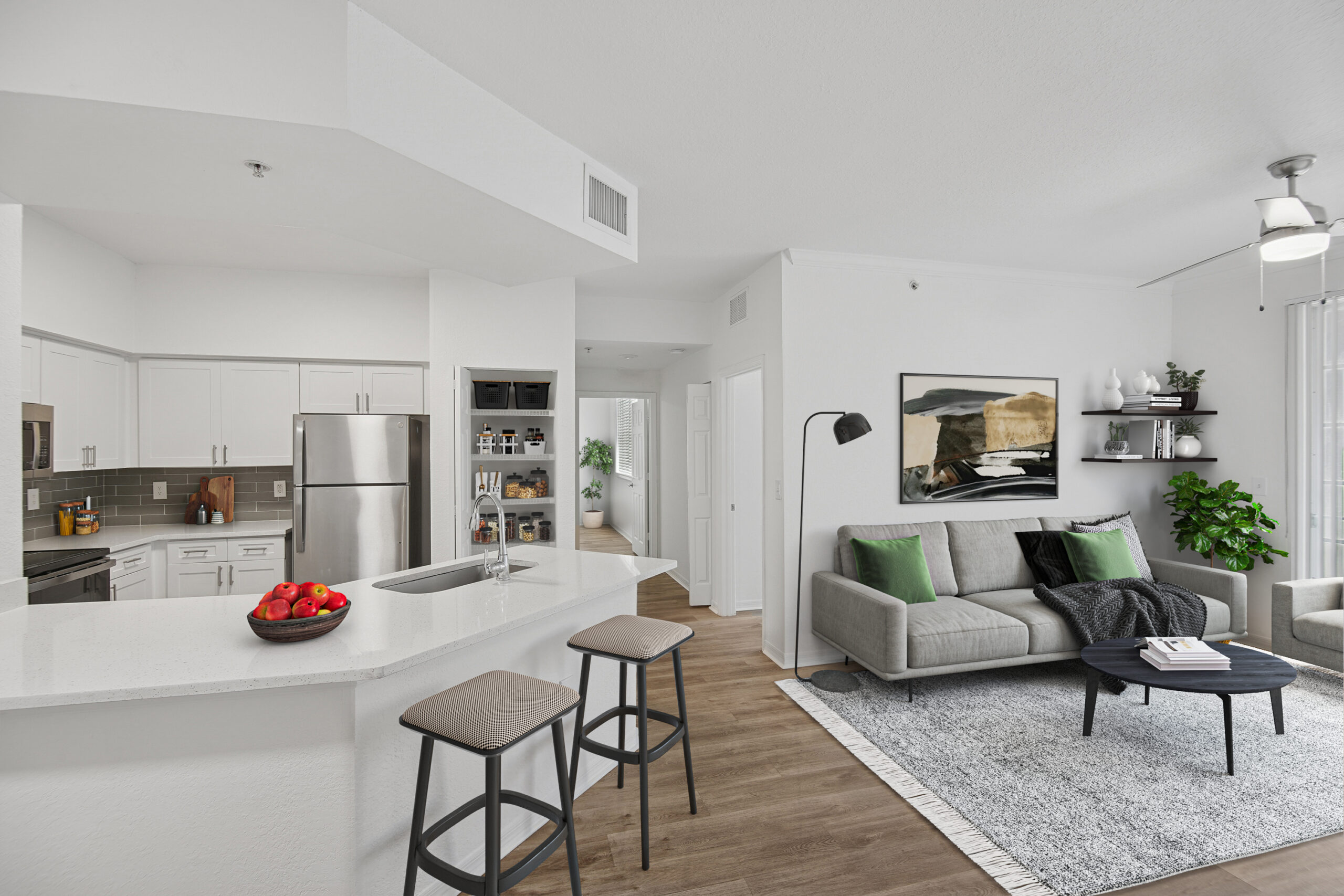 Spacious modern living room and kitchen with stainless steel appliances and granite countertops
